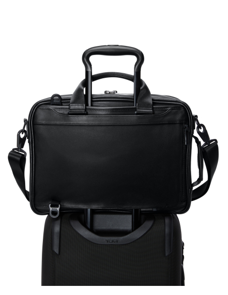 Porte-documents Three-Way TUMI Alpha Black, passant installé sur une poignée de valise
