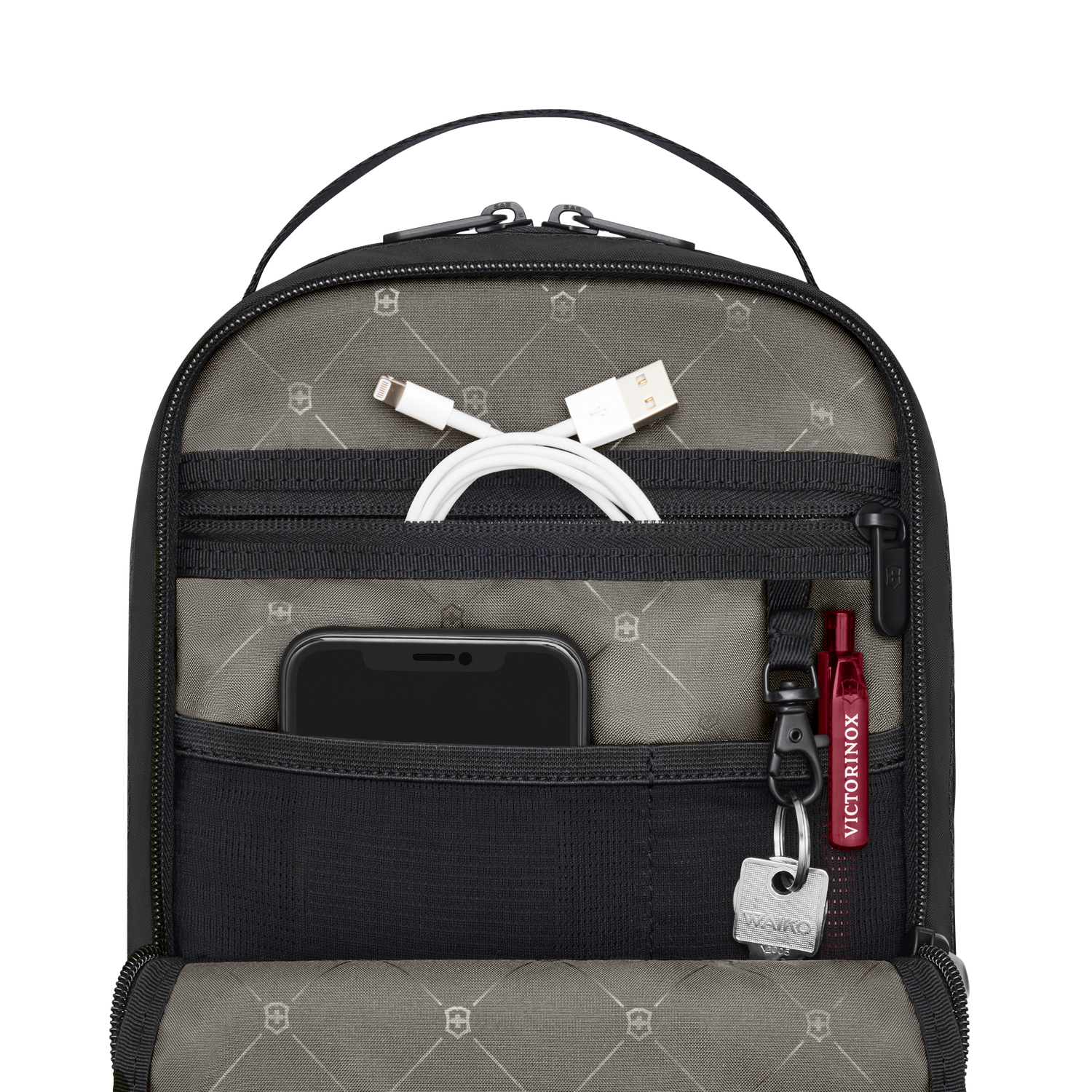 Détail des rangements du Crossbody Victorinox Travel Essentials avec téléphone, câble et clés