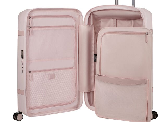 Intérieur d’une valise Samsonite Image rose, avec séparateurs, poches et sangles de rangement.