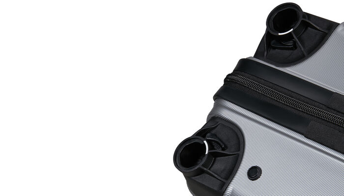 Emplacements des roues retirées sur une valise Flashline American Tourister